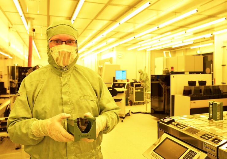 Photo-Credit-Bart-van-Overbeeke-Smart-Photonics-picture-of-Luc-Augustin-with-wafer-containing-photonic-chips